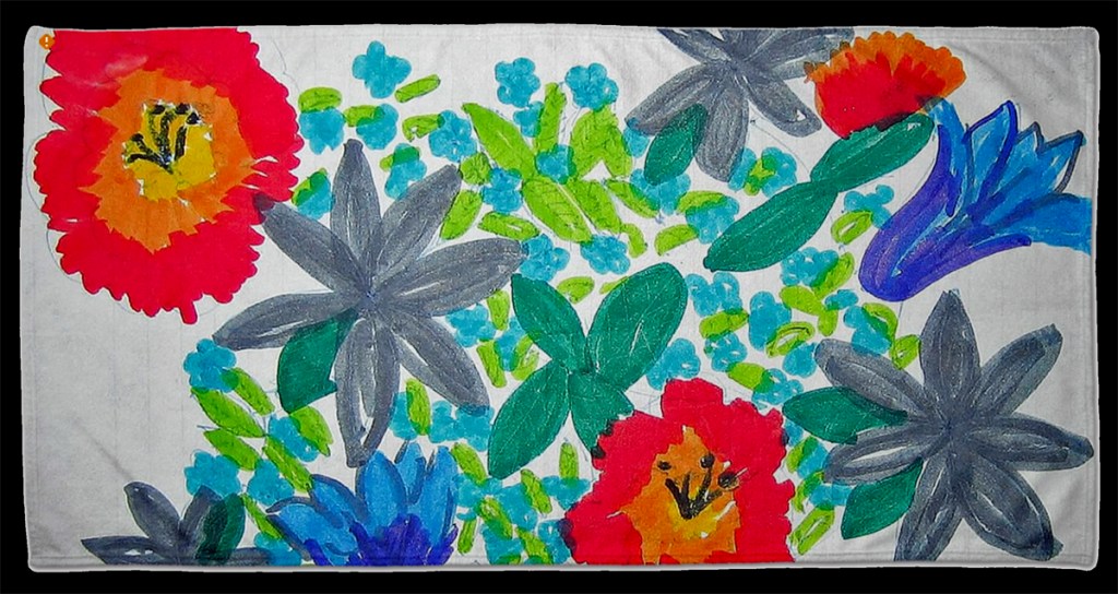 This photo is an illustration of the beach towel with the child's flower drawing.
